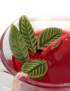 Top view of red tea glass gel candle with mint leaf detail