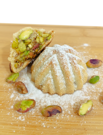 Cut open Syrian pistachio maamoul showing rich local Halabi pistachio filling