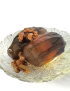Preserved Syrian baby eggplants topped with local walnuts on a glass serving plate
