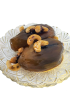Glass dish serving of Syrian eggplant jam topped with whole cashews