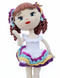 Celina handcrafted crochet doll posing in colorful ruffle dress