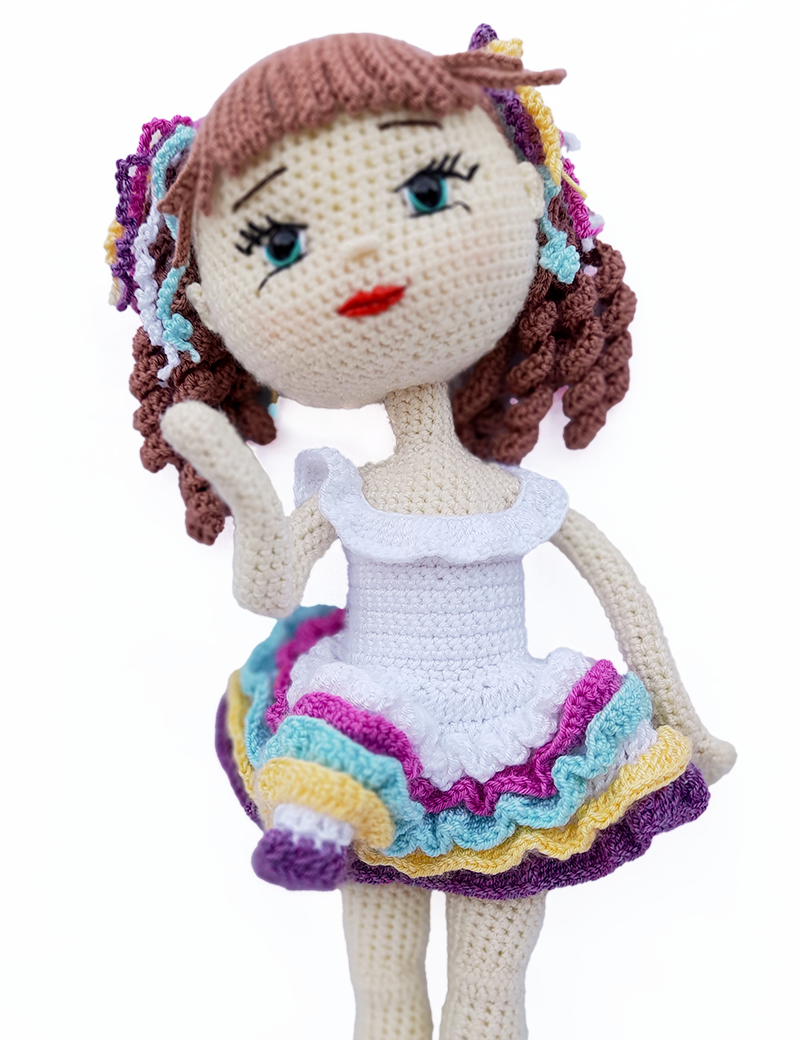 Celina handcrafted crochet doll posing in colorful ruffle dress