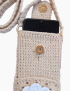 Close-up of smartphone inside crochet bag with gold magnetic snap