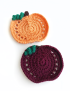 Set of two handmade crochet pumpkin coasters in orange and burgundy