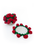 Unfolded handmade crochet floral coaster with red rose border alongside holder.