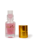 10ml bottle of pink Pomegranate Musk body oil with gold lettering and cap removed.