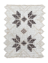Overhead view of the small square beaded doily with central brown floral design.