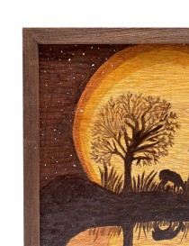 Close-up of wood grain and star details on a hand-burned landscape.