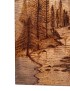 Detailed pyrography showing pine trees and mountain peaks etched into wood.