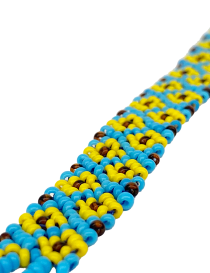 Macro shot of the intricate sunflower beadwork detail and fine stitching.