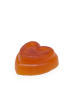 Side profile of a handmade turmeric soap showing the tiered heart design.