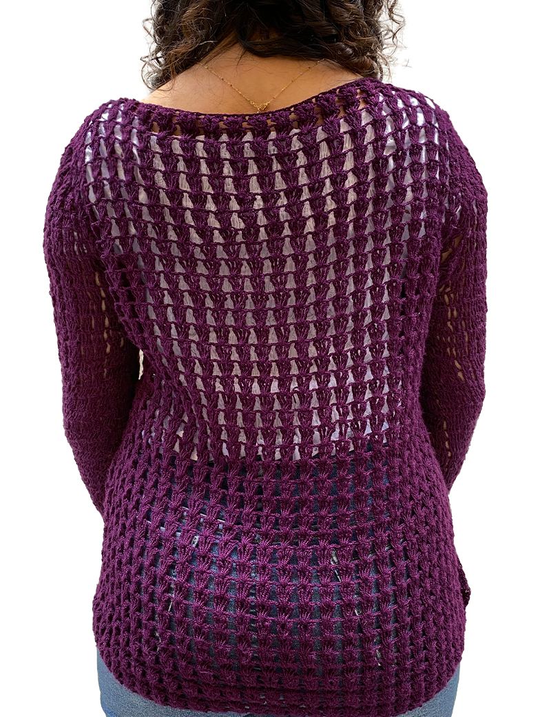 Side profile of woman in purple crochet top highlighting the sleeve fit and lace texture.
