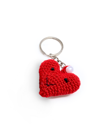 Single handmade red crochet heart keychain featuring a cute face and white pearl.
