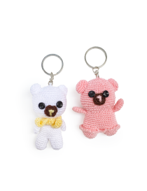 Two handmade crochet teddy bear keychains in white and pink colors.
