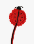 Detailed view of a red crochet ladybug with black embroidered spots and antennae.