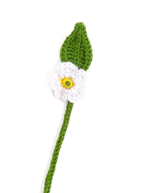 Detailed view of a crochet white strawberry blossom and green ribbed leaf.