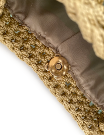 Interior detail of the smooth brown fabric lining and magnetic gold metal fastener.