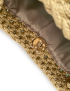 Interior detail of the smooth brown fabric lining and magnetic gold metal fastener.