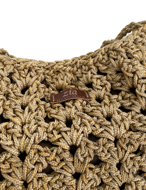 Close-up of textured crochet stitching and leather "Zia Handmade" logo tag.