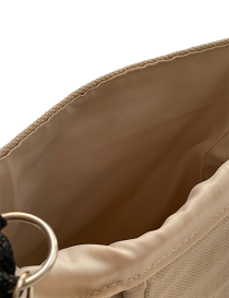 Close-up of the soft cream satin interior lining and stitching.