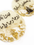 Close-up of resin wedding coaster showing gold leaf flakes and Arabic calligraphy.