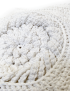 Detailed view of handmade crochet loops and textured yarn patterns.