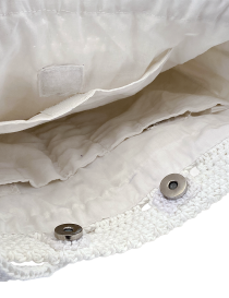 Silver metal ring connecting the sturdy white crochet shoulder strap.