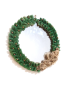 Round wall mirror with braided jute rope frame and beaded tassel bow.