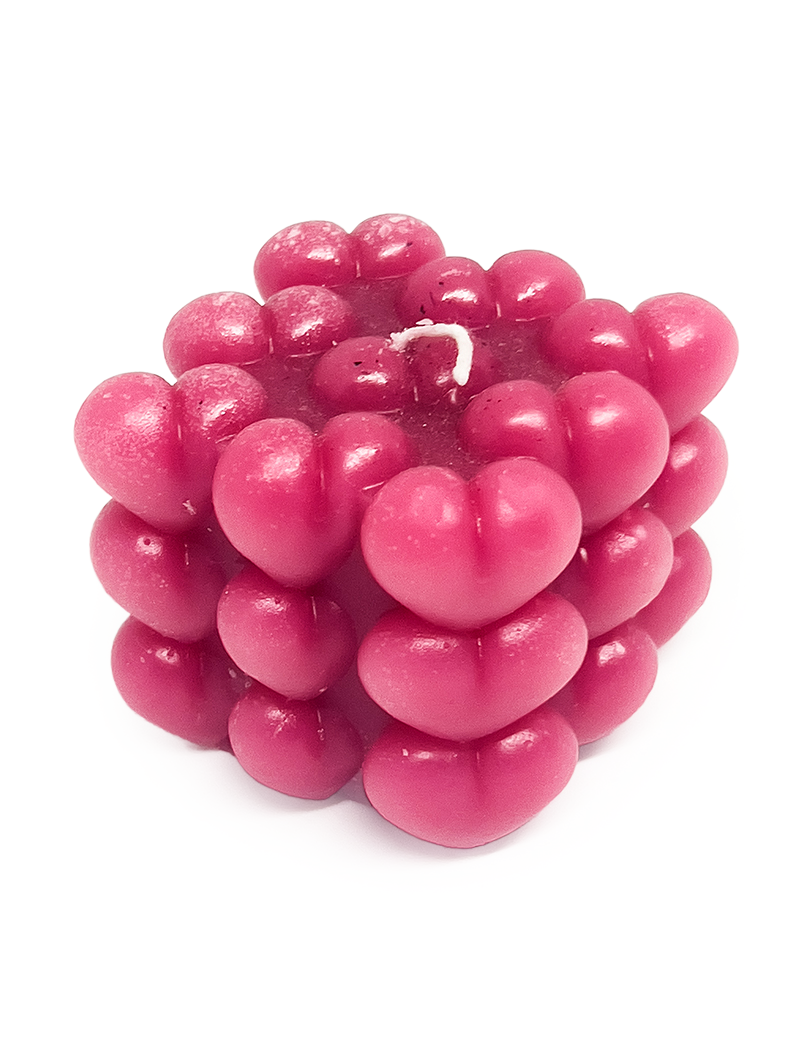 The candle has a single white wick on top and is photographed against a clean, white background.