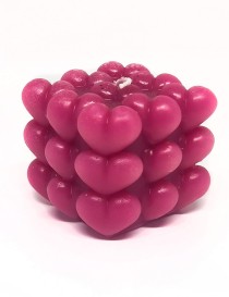 A square sculptural pillar candle made of many small 3d Hearts