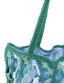 Teal and lavender mesh crochet bag with fabric lining and long shoulder straps.