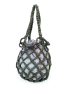 Dark olive green mesh crochet bag with braided handles and a patterned fabric inner sack.