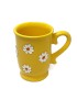 Hand-painted yellow ceramic mug with white daisy floral design and decorative handle.
