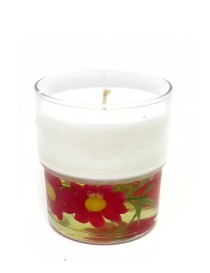 White wax candle in glass jar with pink flowers embedded in a gel base.