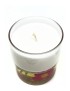 White wax candle in glass jar with pink flowers embedded in a gel base.