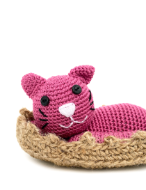 Close-up of crochet cat face showing button eyes and embroidered whiskers.