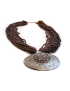 Side view of amber brown seed bead necklace and silver medallion.