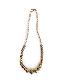 Full view of gold statement necklace with raw crystal center.