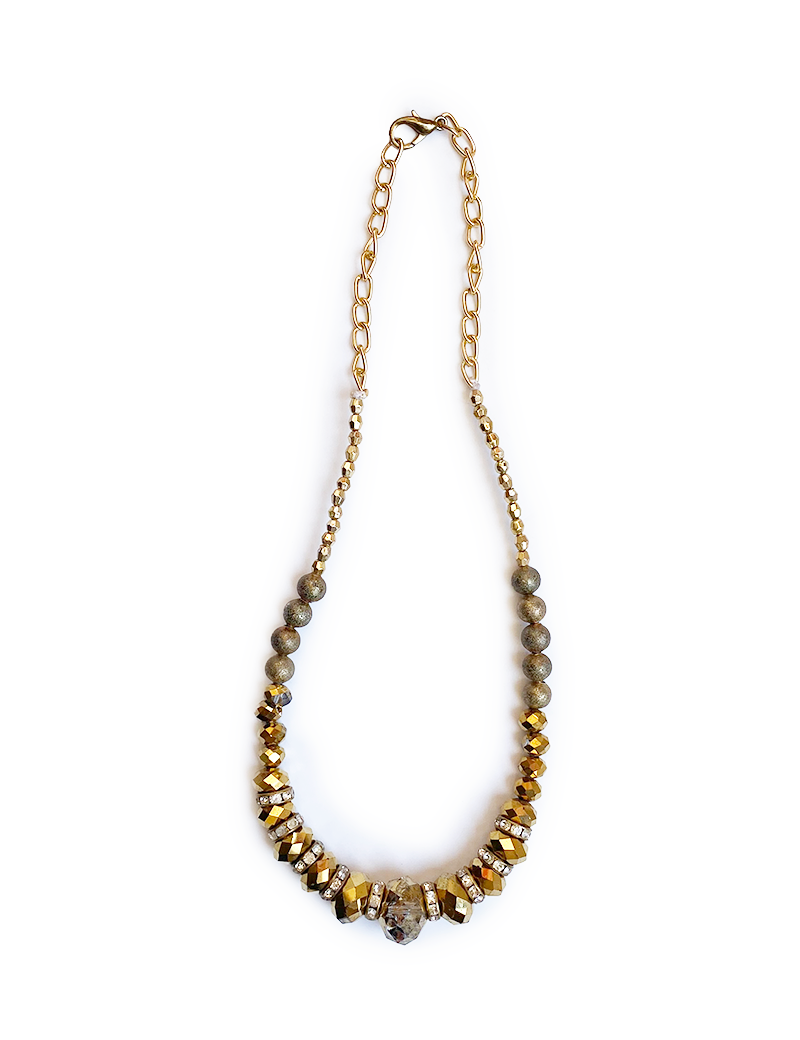 Full view of gold statement necklace with raw crystal center.