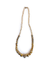 Full view of gold statement necklace with raw crystal center.