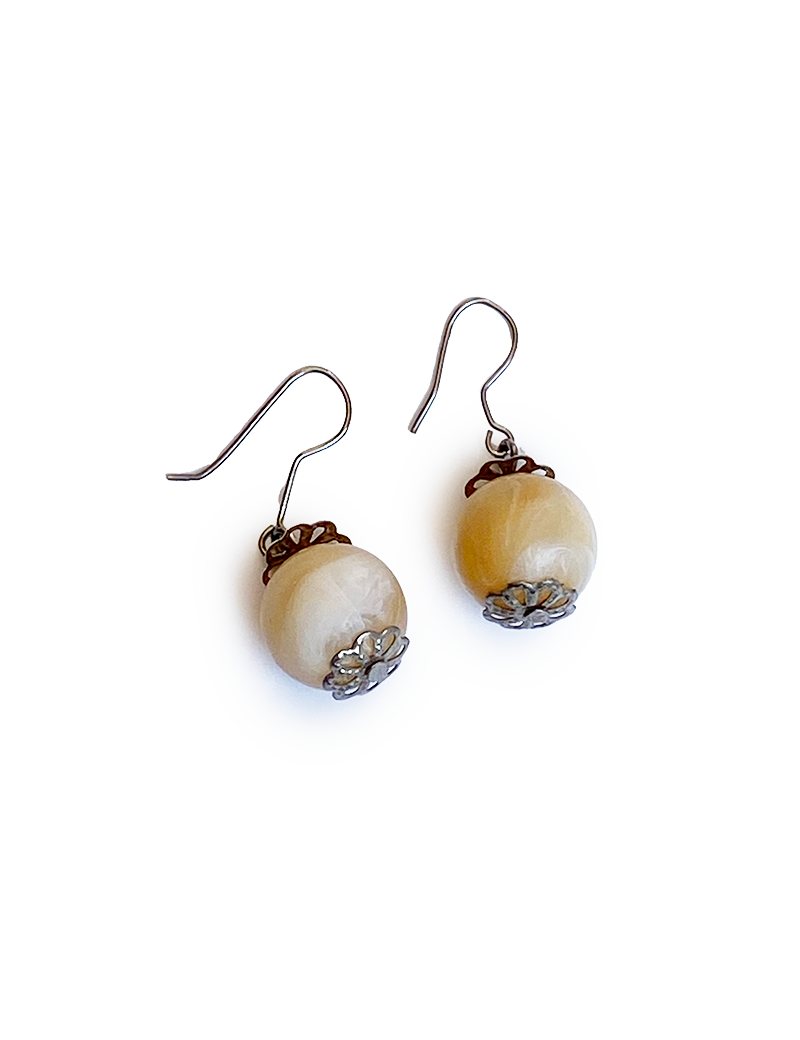 Cream colored marbled stone bead earrings with silver filigree accents.
