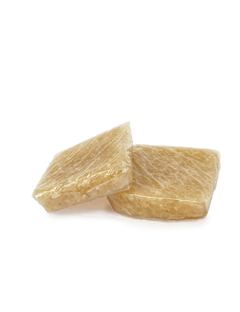 Two square pieces of Almond Harissa wrapped in clear film.