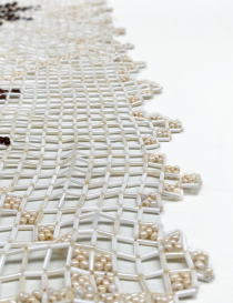 Macro shot of the beaded edge showing the high-quality craftsmanship and thread.