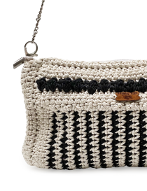 Close-up of mercerized cotton crochet pattern and "Hala Sh" leather brand tag.