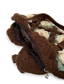 Inside view showing the brown fabric lining and secure zipper of the crochet bag.