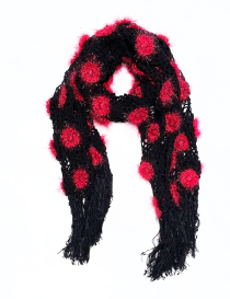 Full view of the red rose crochet scarf styled in a loop with fringe.