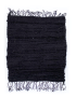 Flat lay of a hand-loomed recycled black fabric rug with fringe.