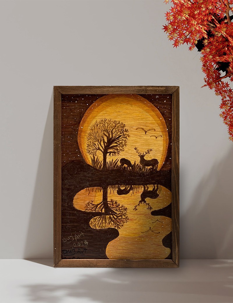 Mockup of Hand-burned pyrography of two deer by a lake with sunset reflection in a wood frame.