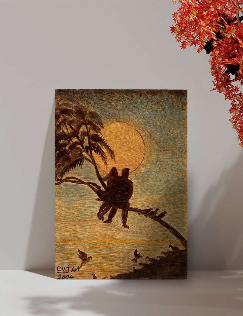 A4 wood burned artwork of two lovers sitting on a tree branch at sunset.