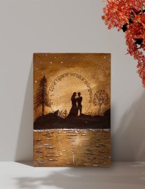 Woodburned A4 art of lovers silhouette under a moonlit sky.